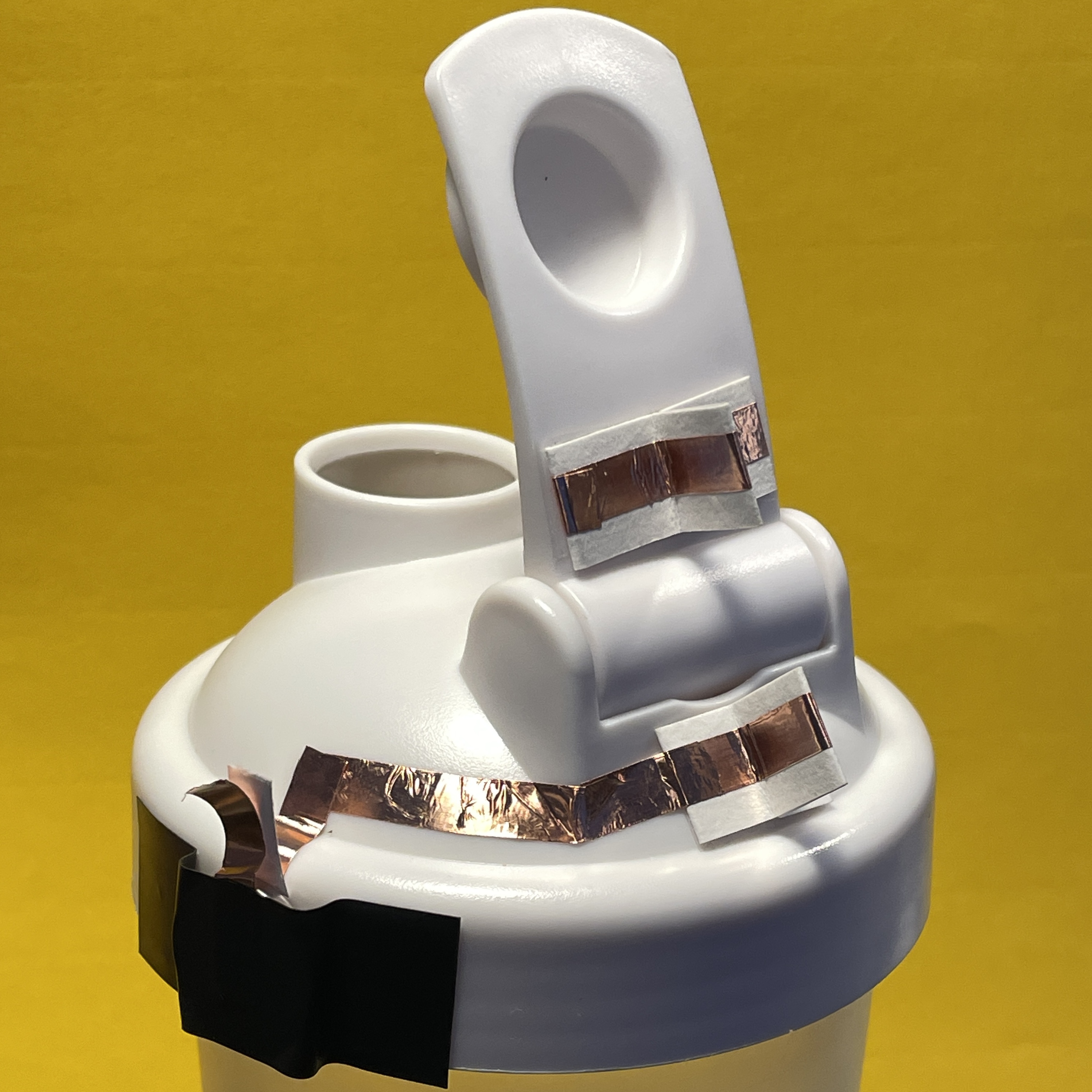 For this I had the idea for an indicator light to show when the bottle is open, to prevent accidental spills. 
    I had to use electrical tape between copper tape to separate (+) and (-) wiring and conductive thread at the hinge. I also used card-stock posts and magnets for the connection point. 
    This worked well however I realized the light only goes on once fully open, which is not ideal it should go on as soon as the cap is lifted. <a href='https://youtube.com/shorts/VwCso8E0NOU?feature=share' target='_blank'><p>Bottle Video</p></a>